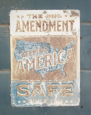 Weathered sign reading The 2nd Amendment Keeps America Safe