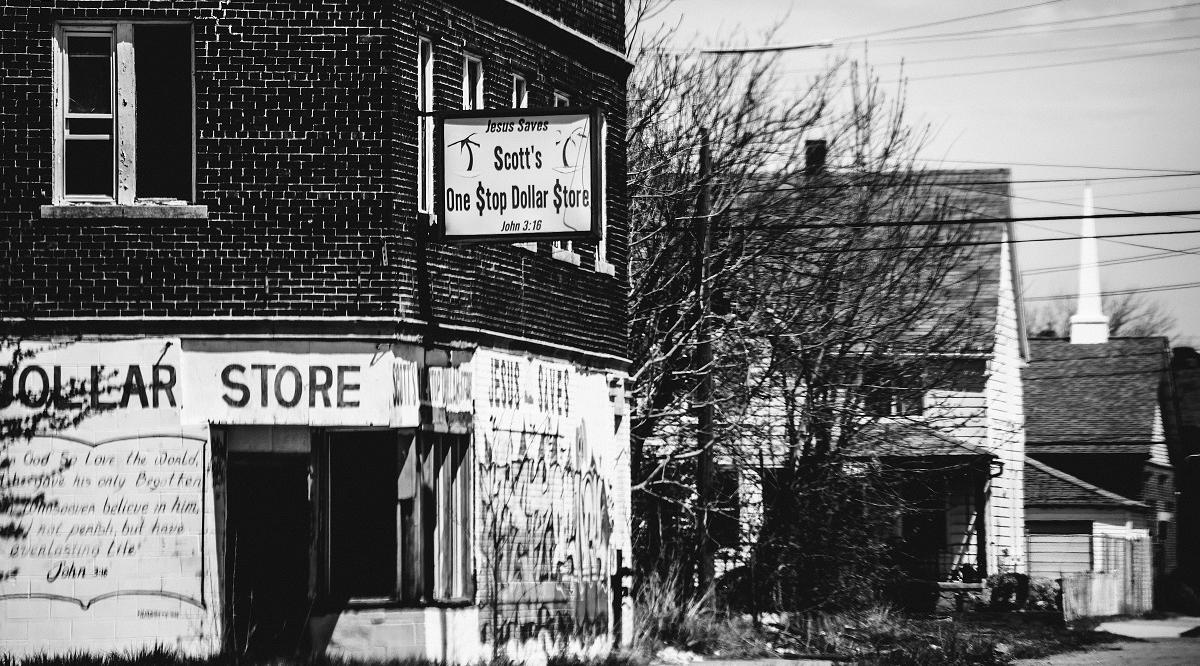 Black-and-white photograph of the vacant Scott's One Stop Dollar Store in a Detroit neighborhood